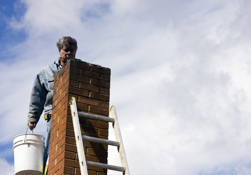 man climbs up the chimney